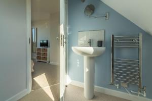 a bathroom with a sink and a mirror at High View in Wells next the Sea +27 photos