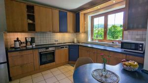 a kitchen with a table with a vase on it at Haus an der Mosel in Bernkastel-Kues
