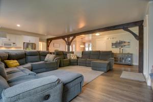 a large living room with a large couch and a living room at Waterfront Home with Hot Tub in Wrightsville! in Wrightsville