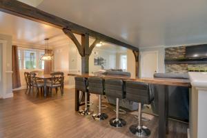 a kitchen and dining room with a bar with chairs at Family Home and Private Hot Tub on Susquehanna River in Wrightsville