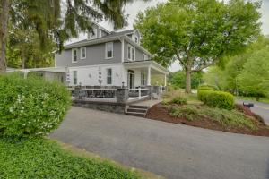 a white house with a porch and a driveway at Waterfront Home with Hot Tub in Wrightsville! in Wrightsville