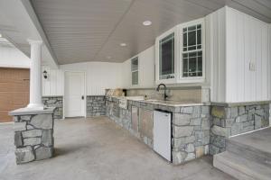 a kitchen with a stone counter and a sink at Waterfront Home with Hot Tub in Wrightsville! in Wrightsville +65 photos