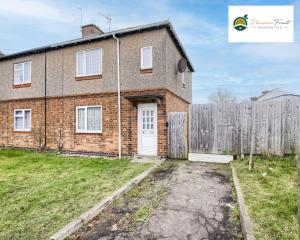 a brick house with a white door and a fence at 3 BedRoom House with 5 Beds House By Passionfruit Properties Near Coventry City Centre - BCC in Coventry