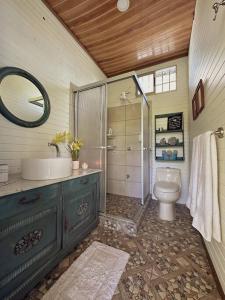 a bathroom with a sink and a toilet at Casa de Campo Riachuelo Verde in Aguas Zarcas