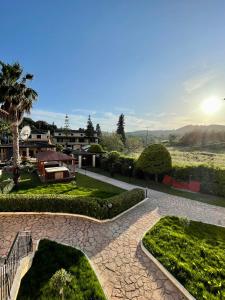 a view of a garden with a patio at Oula Maisonettes Suites in Kavos