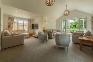 a large living room with couches and chairs at Old Posting in Brancaster