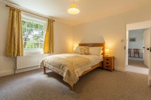 a bedroom with a bed and a window at Old Posting in Brancaster
