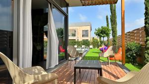 a patio with chairs and a table on a deck at DrVilla°Suits in Belek