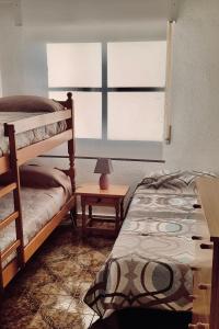 1 dormitorio con 2 literas y ventana en Puerto de Mazarron 300m plage Bahia, en Puerto de Mazarrón
