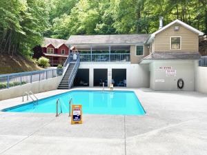 a swimming pool in front of a house at Happy Trails, Hot Tub, In Pigeon Forge Near Strip, Hot Tub, WIFI!!! in Pigeon Forge +23 photos