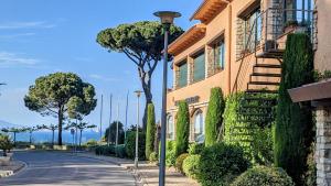 a building with a street light next to a road at Hotel Sa Punta - Adults Only in Begur