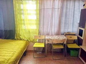 a room with a bed and a table and chairs at Cozy studio in Costa del Silencio in the south coast of Tenerife in Costa Del Silencio +12 photos