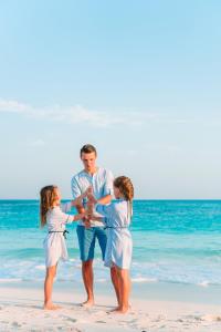 a man and two girls on the beach at Grand Oasis Tulum Riviera - All Inclusive in Akumal