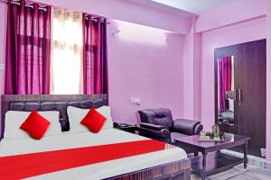 a bedroom with a bed and a desk and a chair at Flagship Hotel The Pinkcity in Patna