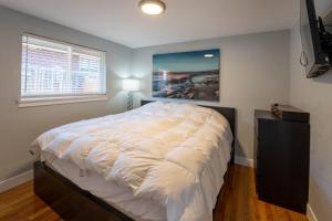 a bedroom with a large bed with a painting on the wall at Hidden Gem of Arvada! in Arvada