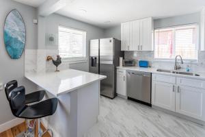 a kitchen with white cabinets and a counter top at Hidden Gem of Arvada! in Arvada