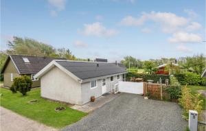 a house with a driveway in a yard at Holiday Home Hemmet 37 in Falen