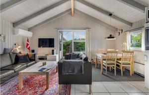 a living room with a couch and a table at Holiday Home Hemmet 37 in Falen +10 photos