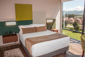 Postel nebo postele na pokoji v ubytování Hotel Sabana Park