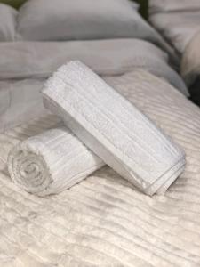 a white towel on top of a bed at TADIJA apartman Niš in Donja Vrežina