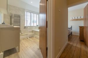 a kitchen with a sink and a counter top at 1 Hall Lane Cottages in Thornham +29 photos