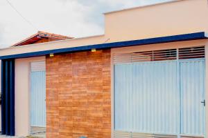a building with two large sliding doors on it at Casa c WiFi e otima localizacao em Barreirinhas MA in Barreirinhas
