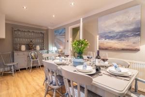 a dining room with a white table and chairs at The Malthouse in Dersingham