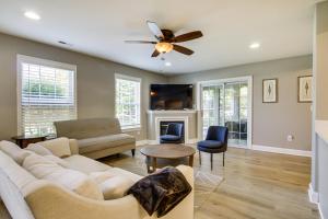 a living room with a couch and a ceiling fan at Charming Lewes Townhome with Sunroom 5 Mi to Beach! in Lewes
