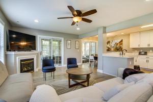 a living room with a couch and a table at Charming Lewes Townhome with Sunroom 5 Mi to Beach! in Lewes