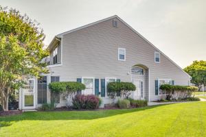 a white house with a lawn at Charming Lewes Townhome with Sunroom 5 Mi to Beach! in Lewes