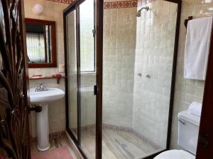 a bathroom with a shower and a sink at Casa Bugambilia, Un Pequeño Hotel en Tepoztlán in Tepoztlán