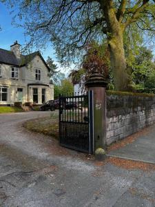 a black gate in front of a brick wall at No.2 Beechcroft / Park-Side / Ping Pong & Garden in Liverpool