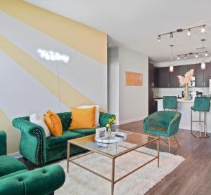 a living room with a green couch and a table at This Is Luxury in Atlanta