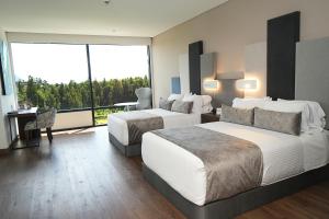 Postel nebo postele na pokoji v ubytování Hotel Sabana Park