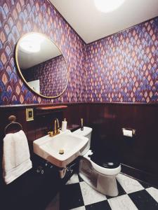 a bathroom with a sink and a toilet and a mirror at Marianna Stoltz House in Spokane