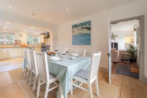 a kitchen and dining room with a table and chairs at Brook House in Briston
