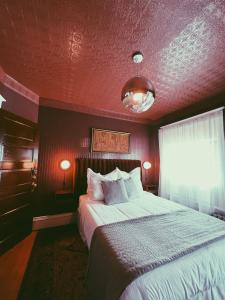 a bedroom with a large bed with a red ceiling at Marianna Stoltz House in Spokane