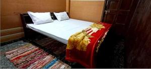 a bed in a room with a bed sidx sidx sidx at OYO Kk Hotel in Meerut