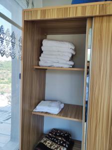 a towel rack with towels in a room at Chalets in the middle of Ajloun forests شاليه و مزرعة في وسط غابات عجلون in Ajloun