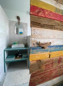 a bathroom with a sink and a wooden wall at La chambre de Séraphine in Biscarrosse