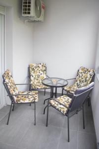 three chairs and a table and a table and chairs at APARTMAN SONJA in Trebinje
