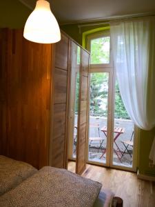 a bedroom with a bed and a sliding glass door at Anna in Anklam