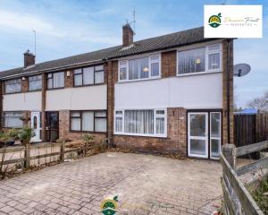 a house with a driveway in front of it at Low Rate 3 Bedroom House Very Close To Coventry Building Society Arena aka Ricoh Arena, Sleeps 8, Free Driveway Parking and Free Wi-Fi, with Garden - RRN in Exhall