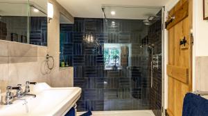 a bathroom with a sink and a shower at Cedar Cottage in Chipping Norton