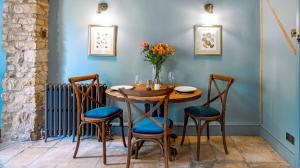 a dining room with a wooden table and chairs at Cedar Cottage in Chipping Norton