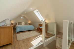 a attic bedroom with a bed and a desk at Tudor Rose in Aylsham