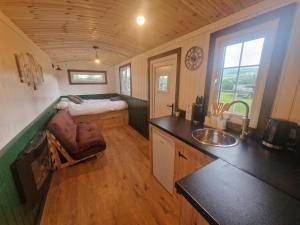 a small kitchen with a sink and a counter top at Cwtch Glamping Shepherds Huts in Abergavenny