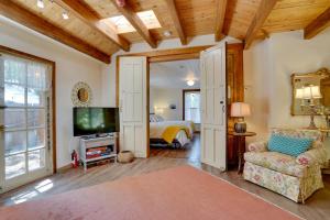 a room with a bed and a tv and a couch at Patagonia Cottage with Patio and Yard Walk to Town! in Patagonia