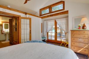 a bedroom with a white bed and a window at Patagonia Cottage with Patio and Yard Walk to Town! in Patagonia