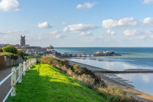 a view of the ocean and a beach at Crabpot Cottage in West Runton